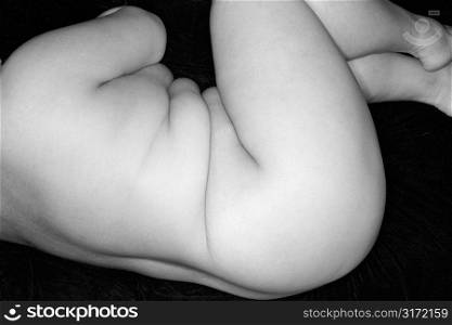 Nude full-figured Caucasian woman lying on side.
