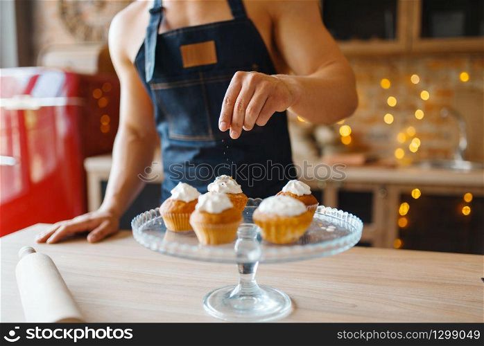 Nude husband in apron cooking dessert with cream on the kitchen. Naked male person preparing breakfast at home, food preparation without clothes