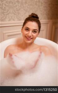Nude woman relaxation in bath with soap top view.. Woman in bath with soap top view