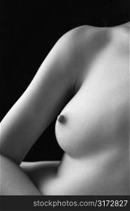 Nude young adult Caucasian female breast and arm.