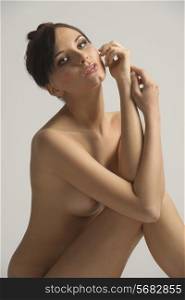 Nude, young, natural skin , sensual woman posing and looking in camera , with natural expression