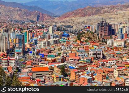 Nuestra Senora de La Paz rapidly growing colorful city suburbs with lots of living houses scattered on the hill in background, Bolivia.