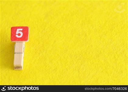 Number 5 displayed on a yellow background