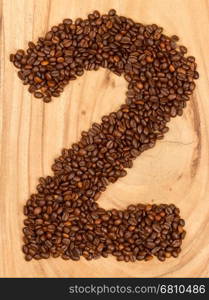 Number from coffee beans, isolated on wood