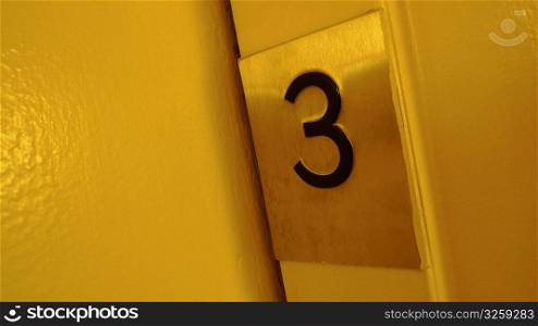 Number three on an elevator door.