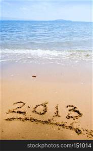 Numbers 2013 on beach - concept holiday background