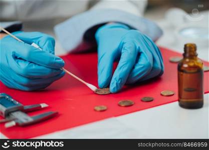Numismatist Cleaning Ancient Coins Collection