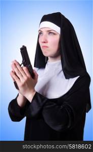 Nun with handgun isolated on white