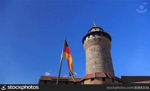 Nuremberg Castle (Sinwell tower) with blue sky and german flag timelapse