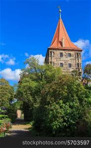 Nuremberg Castle with blue sky and trees in garden&#xA;