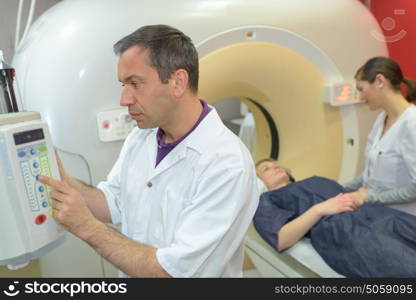 nurse and doctor as they prepare for an axial tomography