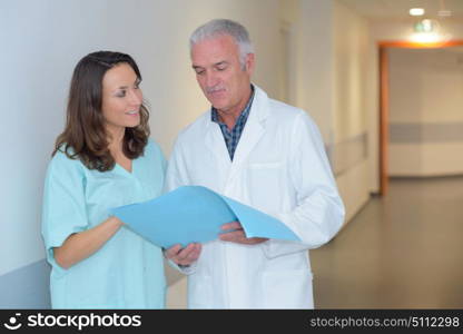 nurse and doctor in hospital corridor