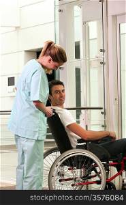 Nurse and patient in wheelchair in front of a lift