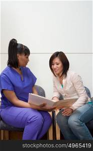 Nurse and patient looking at file