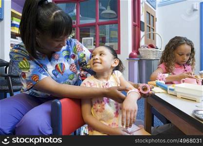 Nurse bandaging girls arm