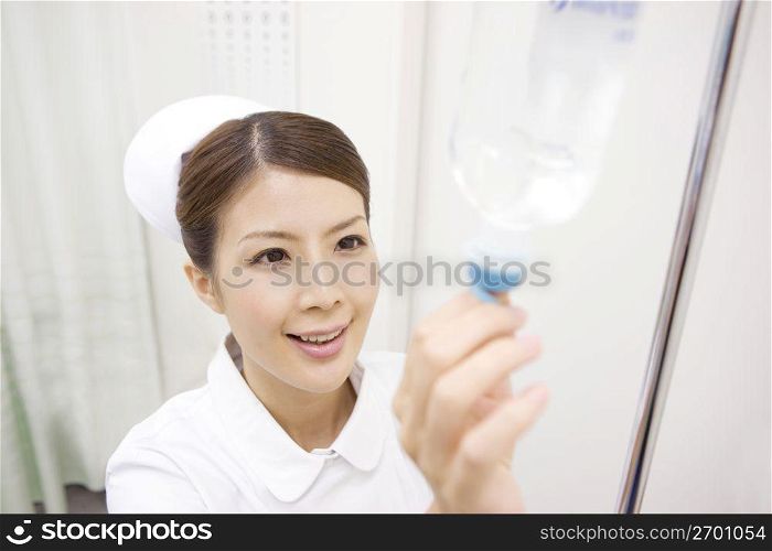 Nurse checking a fluid bag