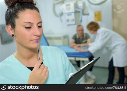 nurse checking a medical report in hospital room