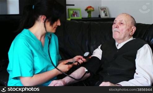 Nurse checking blood pressure to a senior man