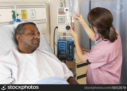 Nurse Checking Senior Male Patient&#39;s IV Drip On Ward