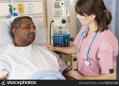 Nurse Checking Senior Male Patient On Ward