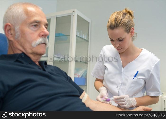 nurse collecting a blood from a patient