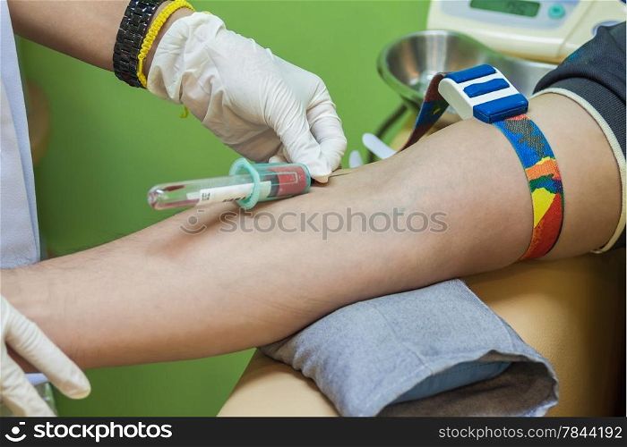 Nurse collecting a blood sample from a patient