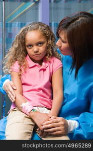 Nurse comforting anxious girl