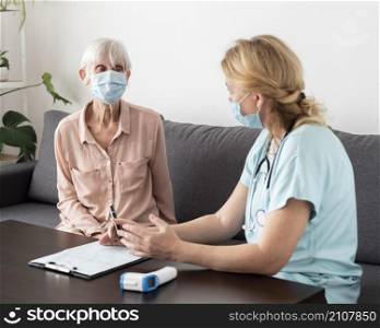 nurse elder woman conversing nursing home