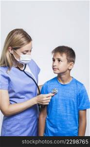 nurse examining boy with stethoscope