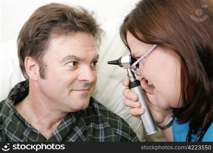 Nurse examining her patient&rsquo;s eyes with an ophtalmoscope.