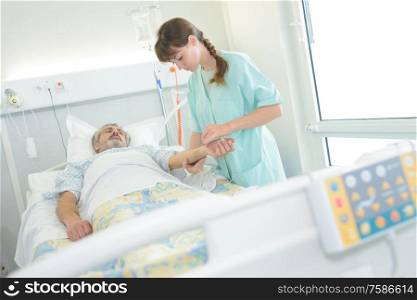 nurse examining his mature patient blood pressure