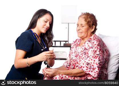 Nurse explaining prescription medication to senior patient, home medical health concept.