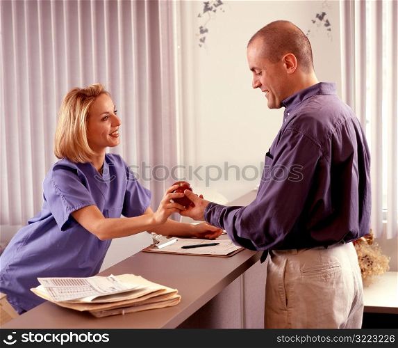 Nurse Giving Man an Apple