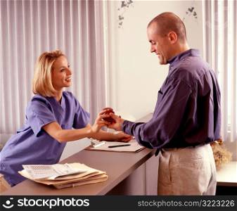Nurse Giving Man an Apple