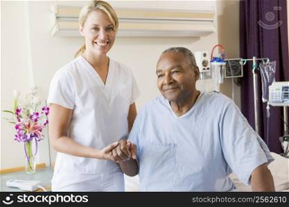 Nurse Helping Senior Man To Walk