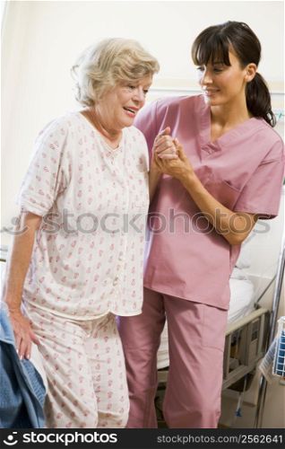 Nurse Helping Senior Woman To Walk