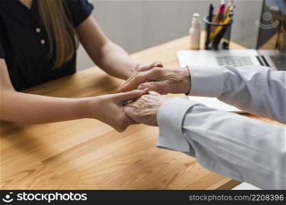 nurse holding senior man s hands