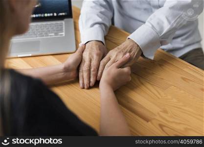 nurse holding senior man s hands relief
