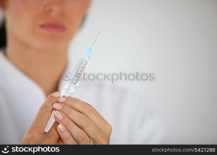 Nurse holding syringe