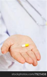 nurse holds pill on palm close up