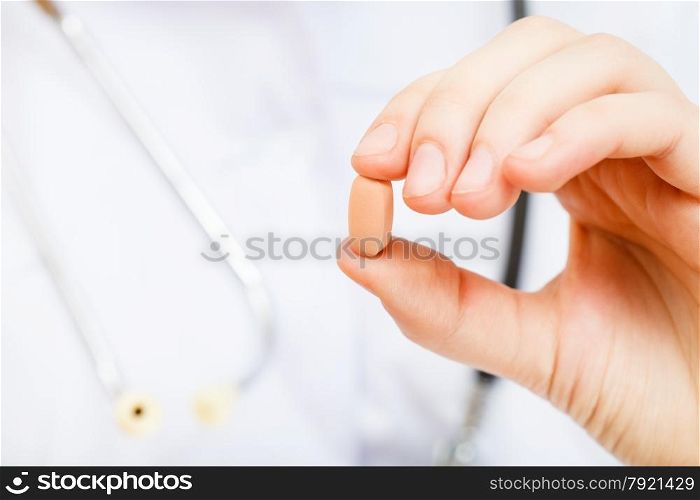 nurse holds tablet in fingers close up
