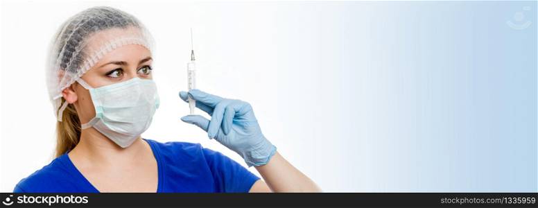 Nurse in a mask with a syringe for injection on white background with copy space