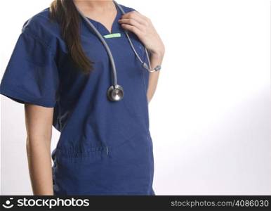 Nurse in scrubs holds her stethoscope