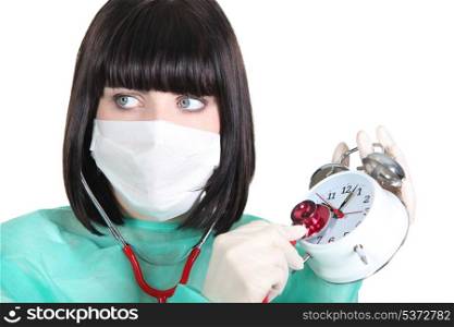 nurse listening the clock ticking with a stethoscope