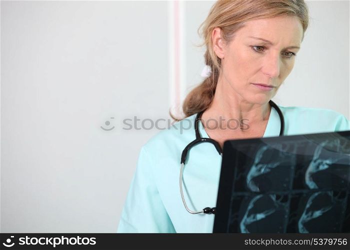 Nurse looking at X-ray