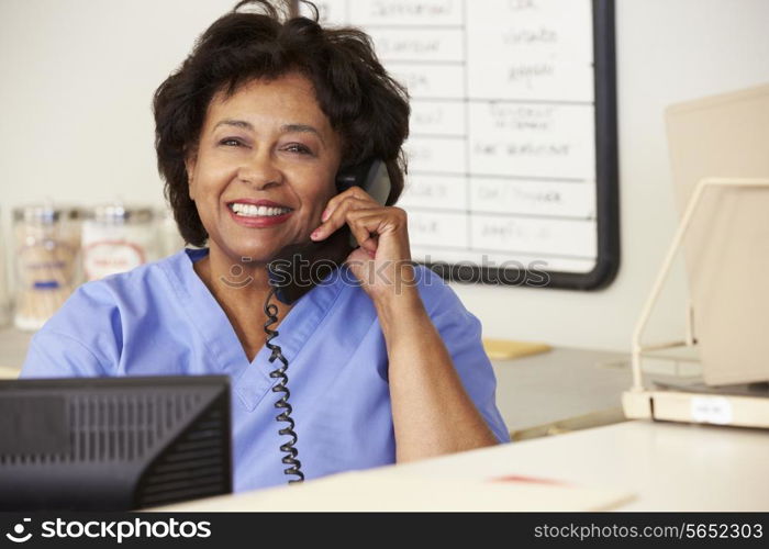 Nurse Making Phone Call At Nurses Station