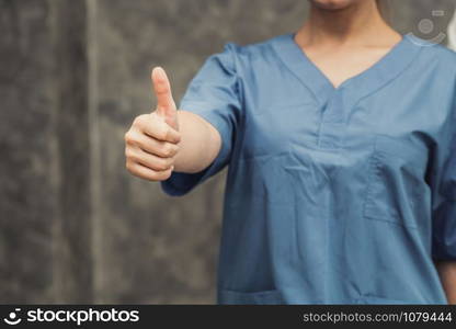 Nurse or doctor showing thumbs up finger. Medical concept.