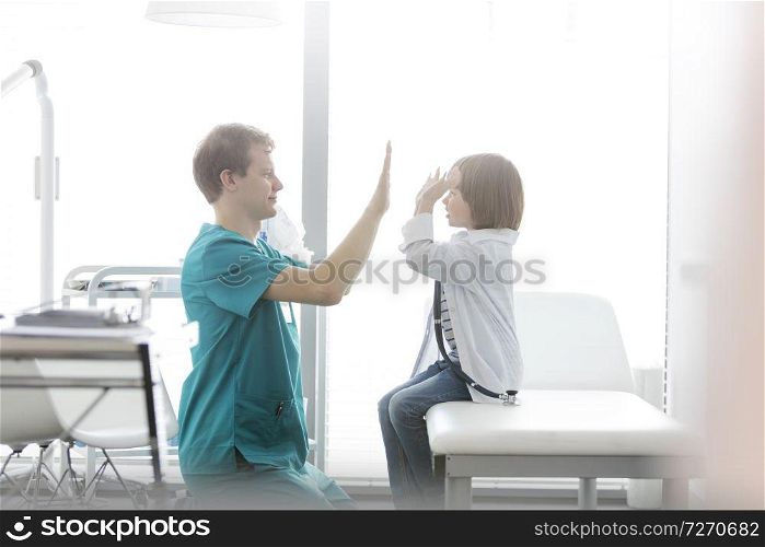 Nurse playing with boy at hospital