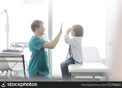 Nurse playing with boy at hospital
