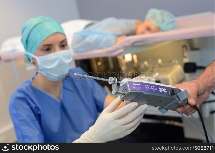 Nurse preparing equipment for medical procedure